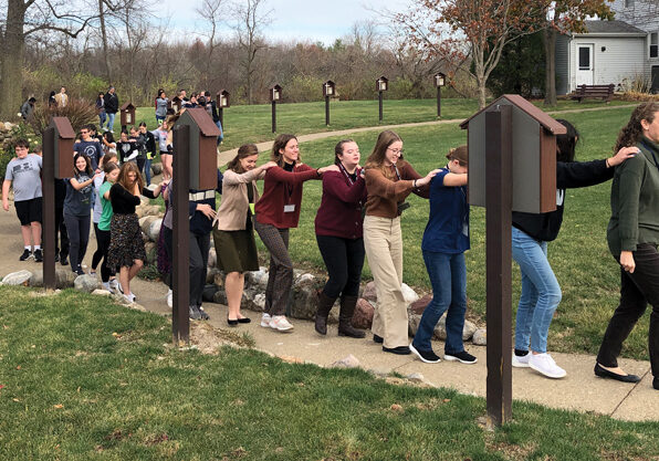 Following a talk, Abide in Me retreatants are led on a "trust walk" around the parish grounds and into St. Mary of Lourdes Church in Germantown Hills by Karen Hertzner, one of the presenters who also served as masters of ceremonies for the weekend. (Provided photo/Katie Bogner)